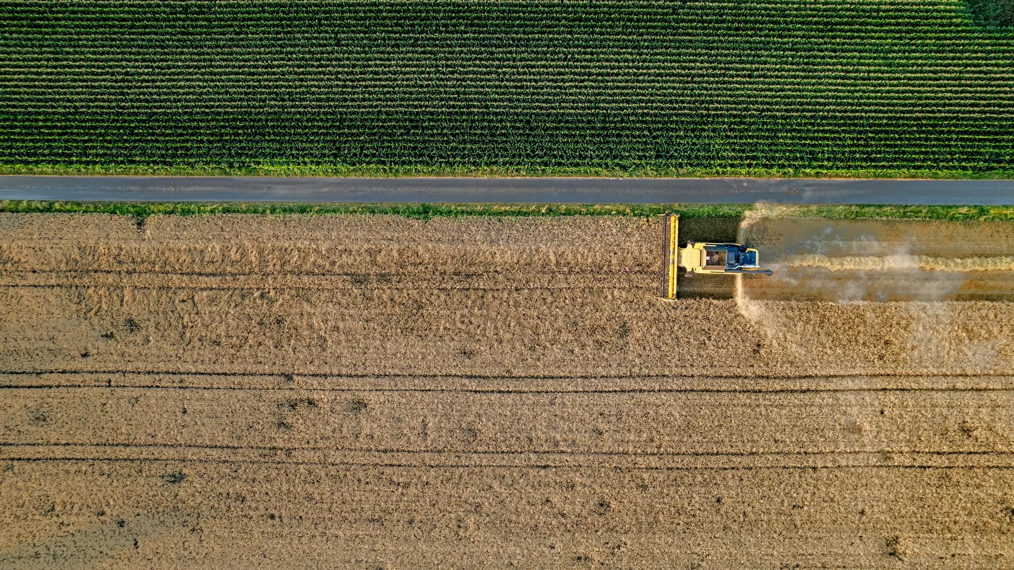 Aerial view of harvesting machinery working a rural Australian property